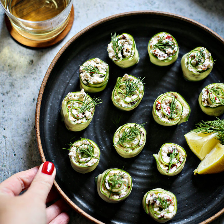 cucumber rolls ups on a black plate