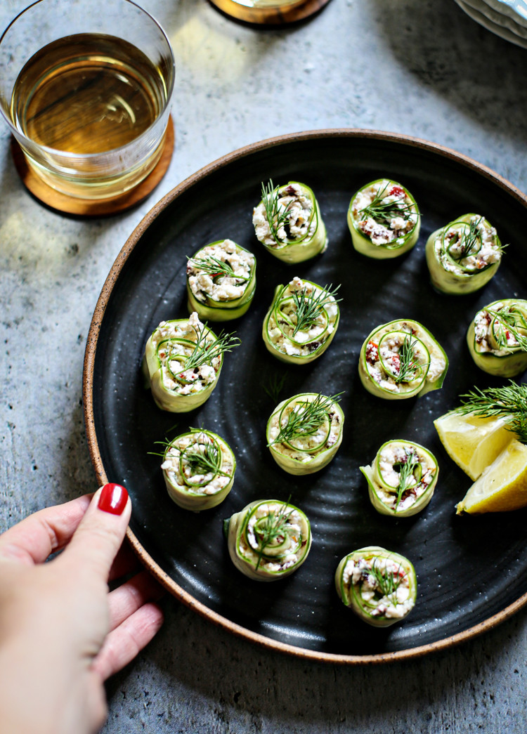 cucumber rolls ups on a black plate