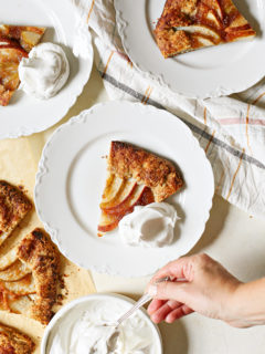 photo of a woman putting whipped cream on plates of pear galette