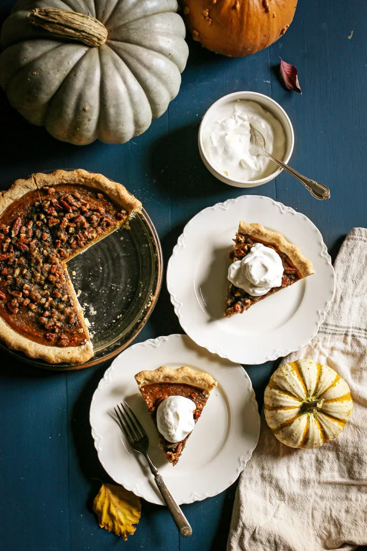 photo of a table set with plate of pumpkin pecan pie and whipped cream