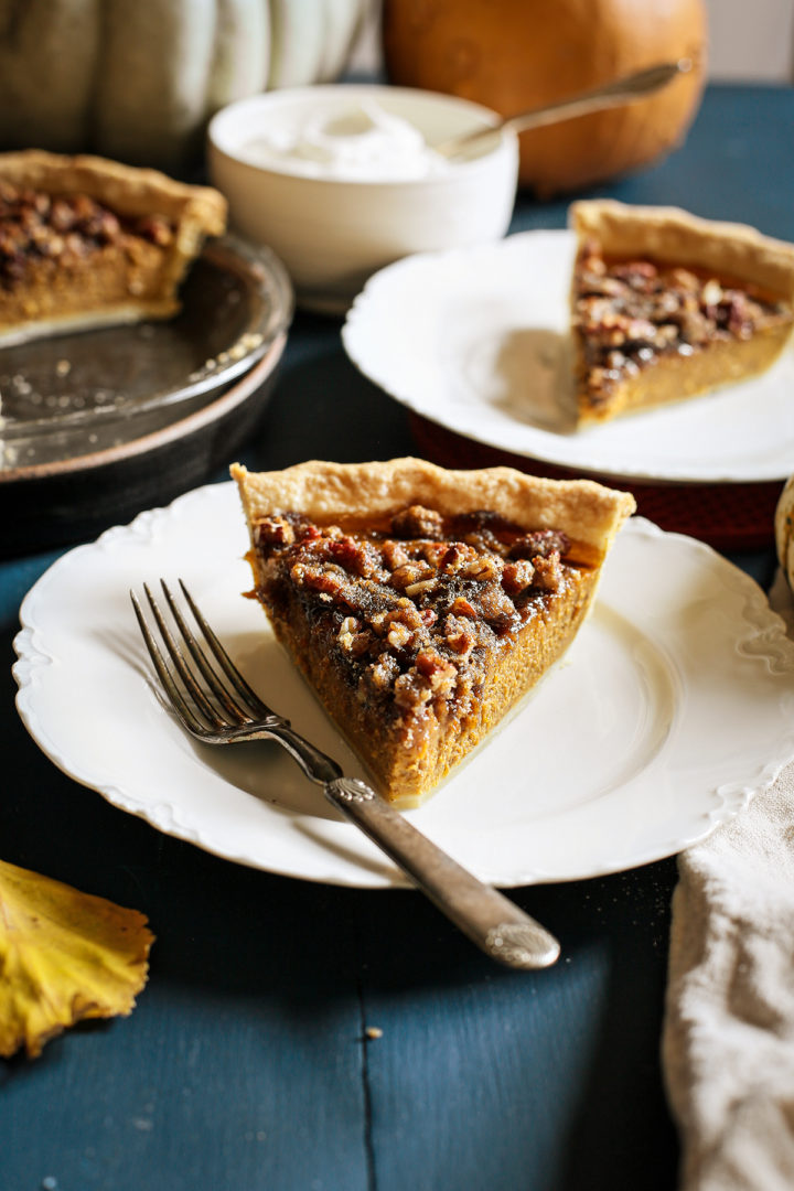 photo of pumpkin pecan pie on a white plate with a fork