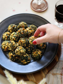 photo of woman with a plate of spinach balls