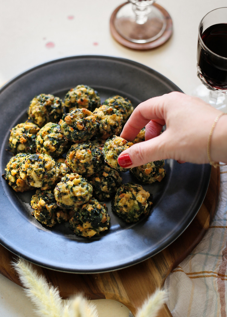 photo of woman with a plate of spinach balls