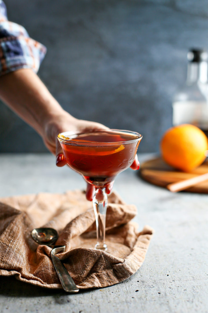 photo of a woman serving a black manhattan