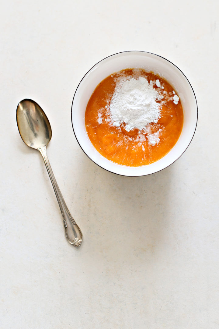 photo of persimmon pulp being mixed with baking soda before making persimmon cookies