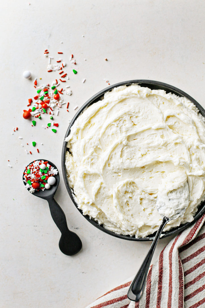 photo of vanilla buttercream frosting and christmas sprinkles for christmas sugar cookie bars