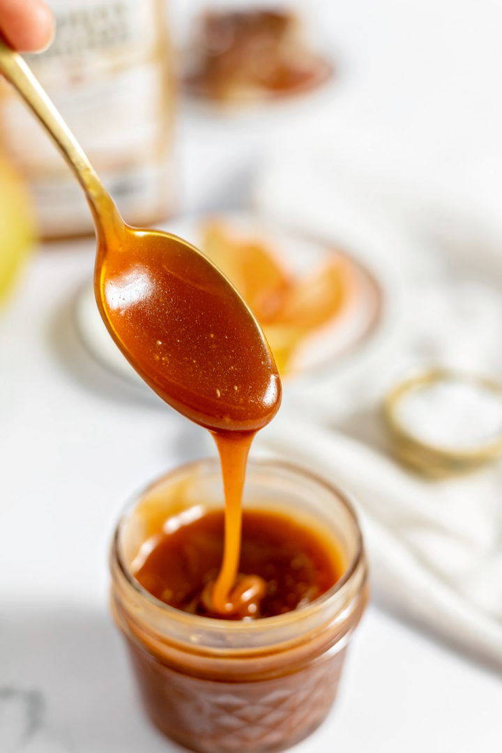 photo of a jar of caramel rum sauce recipe with a spoon full of rum caramel sauce