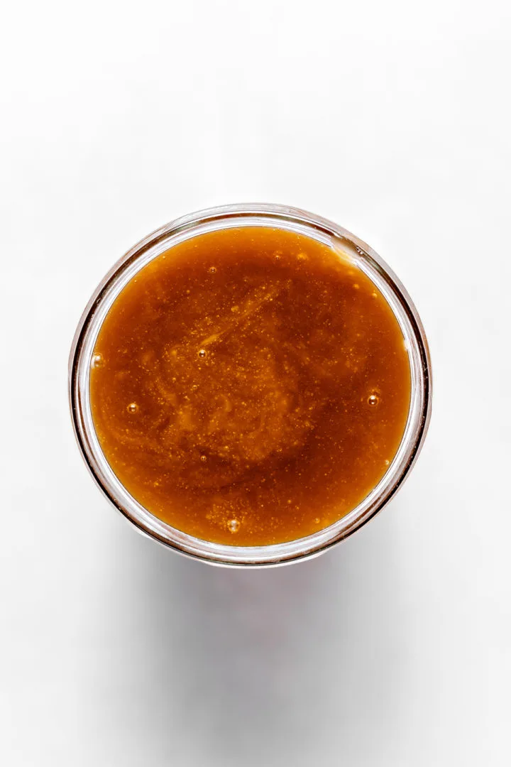 overhead photo of this rum caramel sauce recipe in a jar