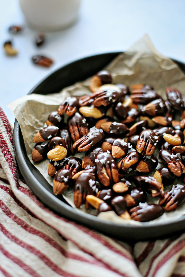 photo of chocolate covered nuts in a black bowl