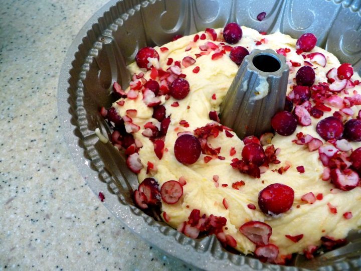 photo of cranberry orange cake batter in a bundt pan before baking
