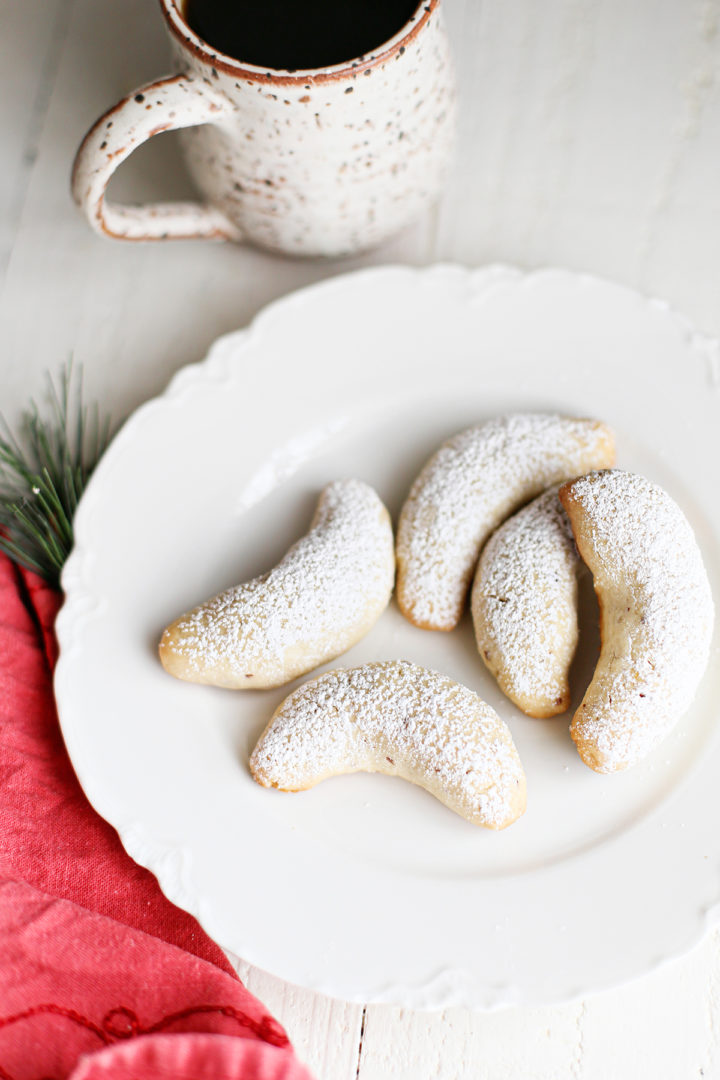 photo of swedish christmas cookies on a white plate with a mug of coffee