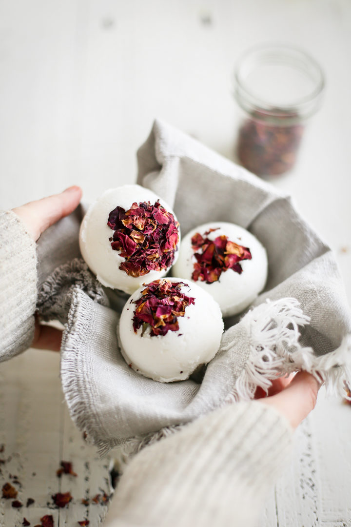 photo of a woman holding a basket of homemade bath bombs