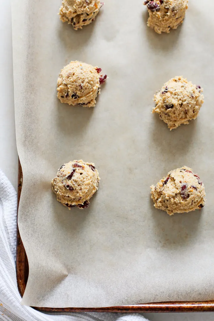 photo of persimmon cookie dough on a baking sheet with parchment paper