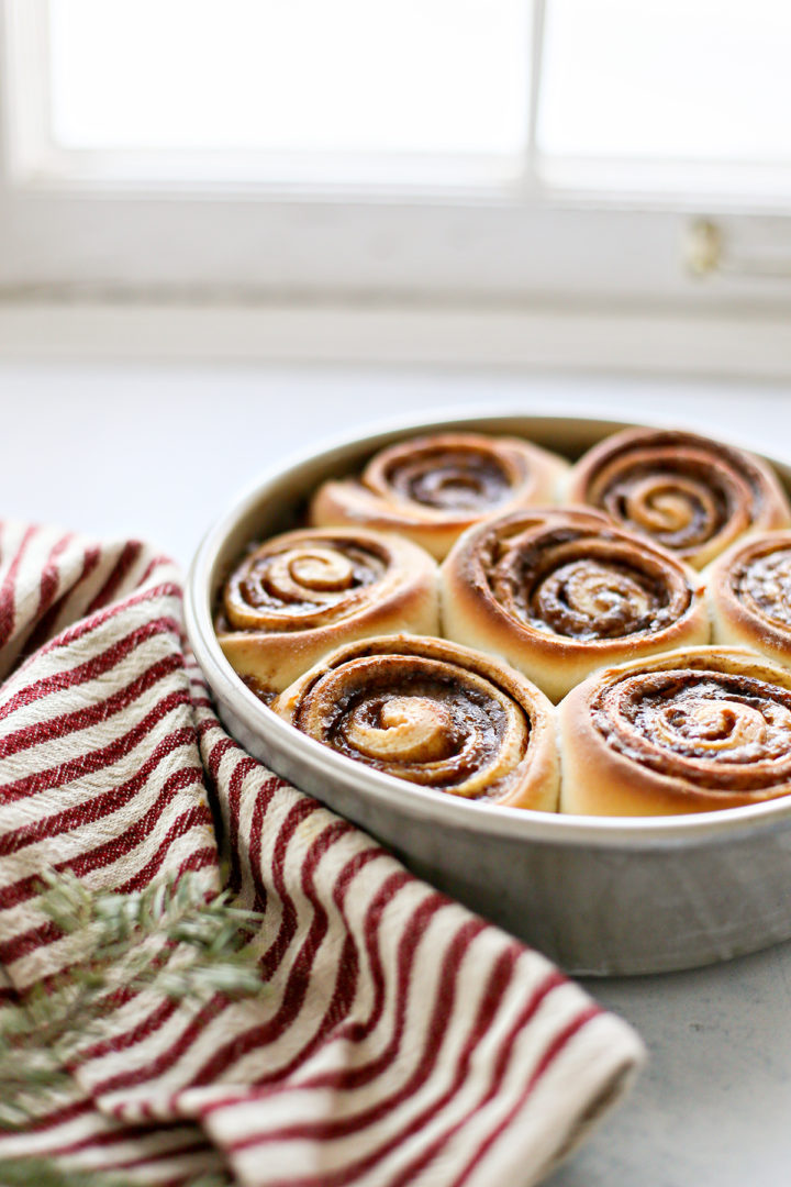 photo of baked homemade cinnamon rolls in a pan on a kitchen counter