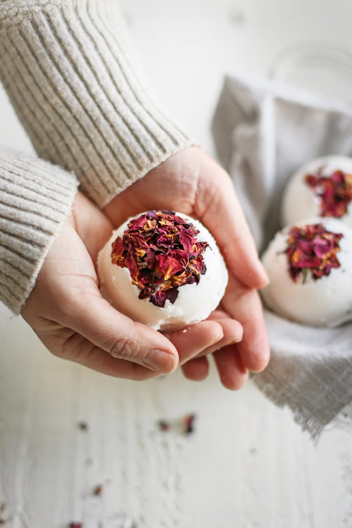 woman holding a homemade bath bomb in her hands
