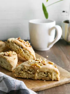 photo of maple scones on a cutting board next to a mug of coffee for brunch