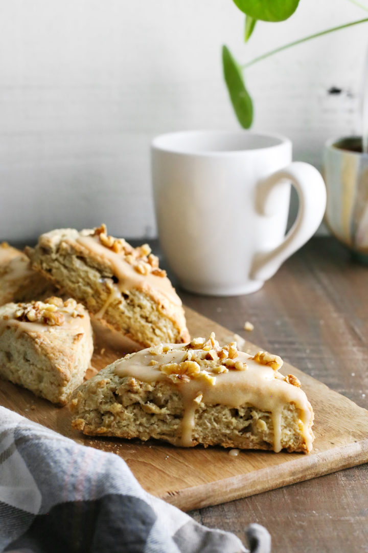 photo of maple scones with sweet maple glaze on a table with a mug of coffee for brunch