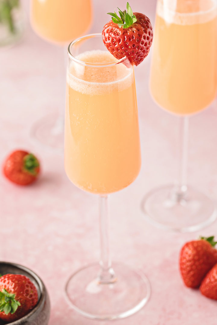 close up photo of strawberry mimosas on a table