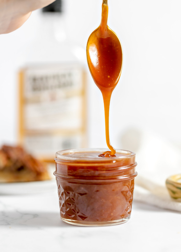 photo of rum caramel sauce drizzling off a spoon