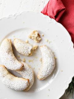 photo of almond crescent cookies on a white plate