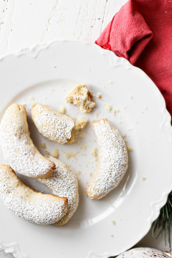 photo of almond crescent cookies on a white plate with a red napkin