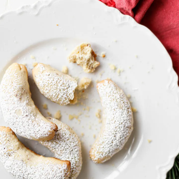 photo of almond crescent cookies on a white plate