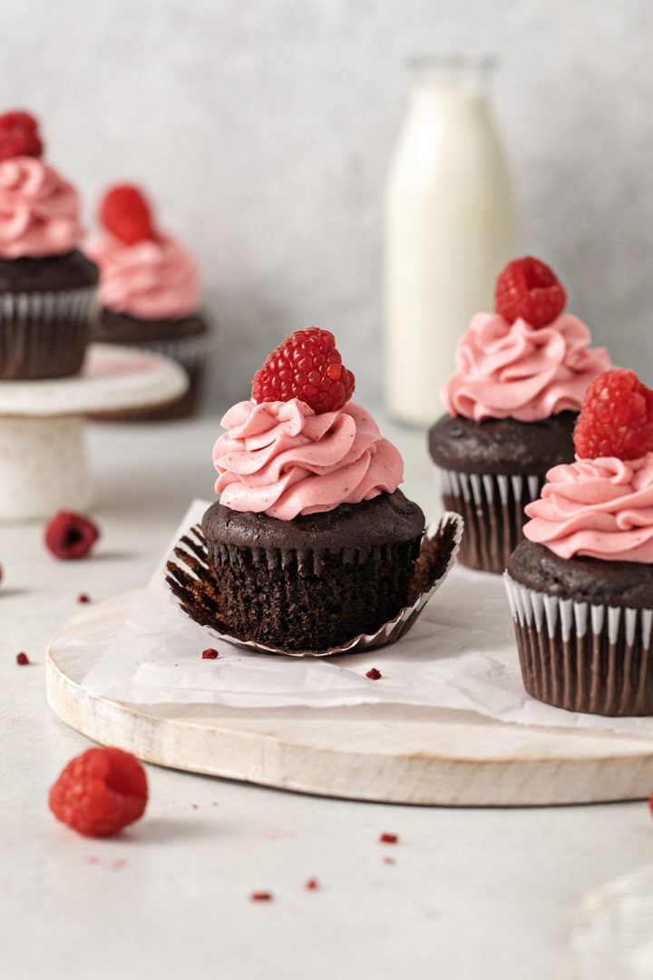 chocolate raspberry cupcakes on a wooden serving board ready to eat