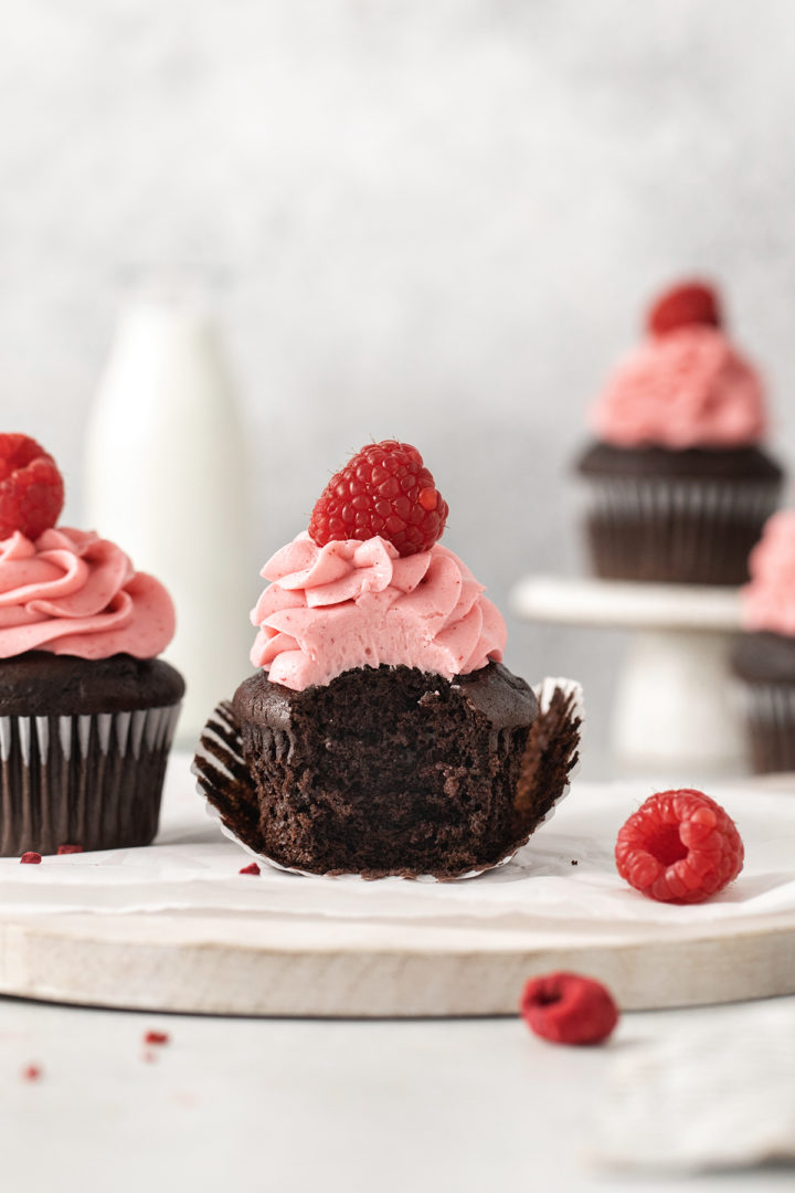 a chocolate raspberry cupcake with a bite out of it