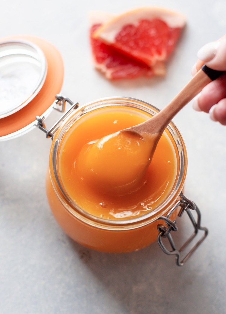 photo of grapefruit curd in a jar with a spoon