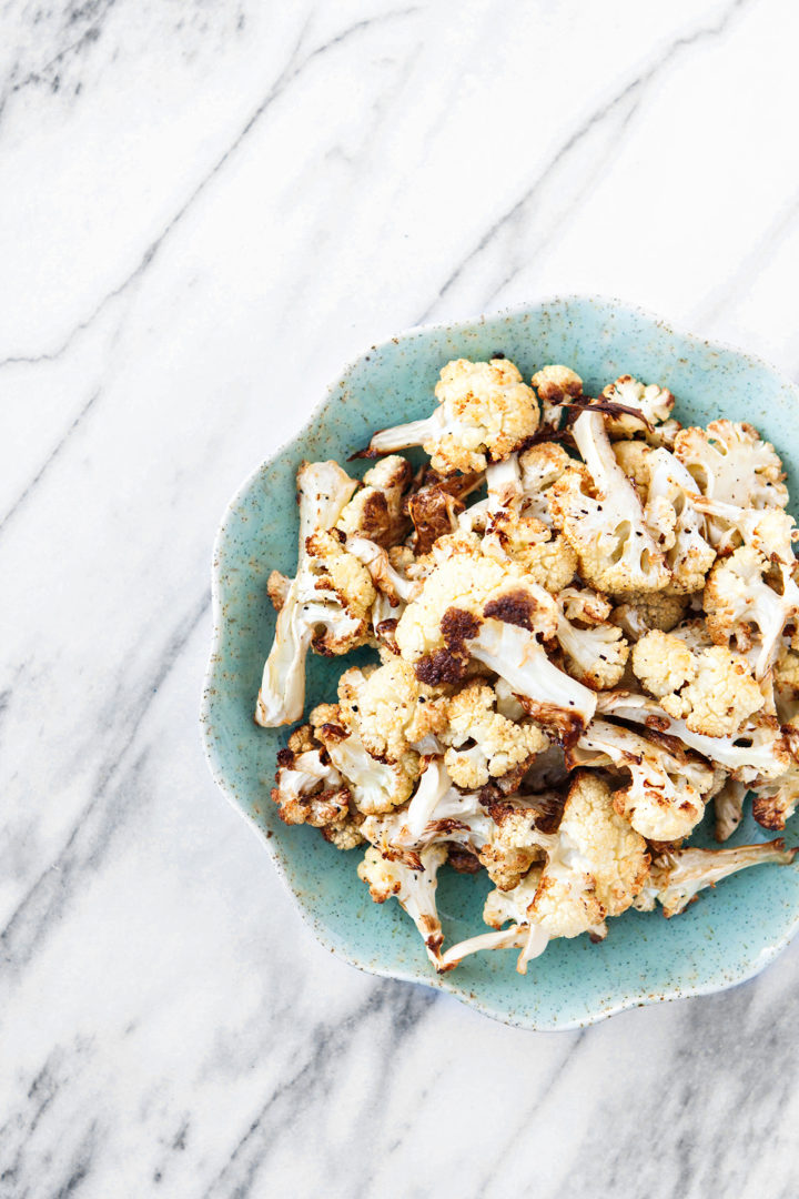 photo of this roasted cauliflower recipe on a plate on a marble counter