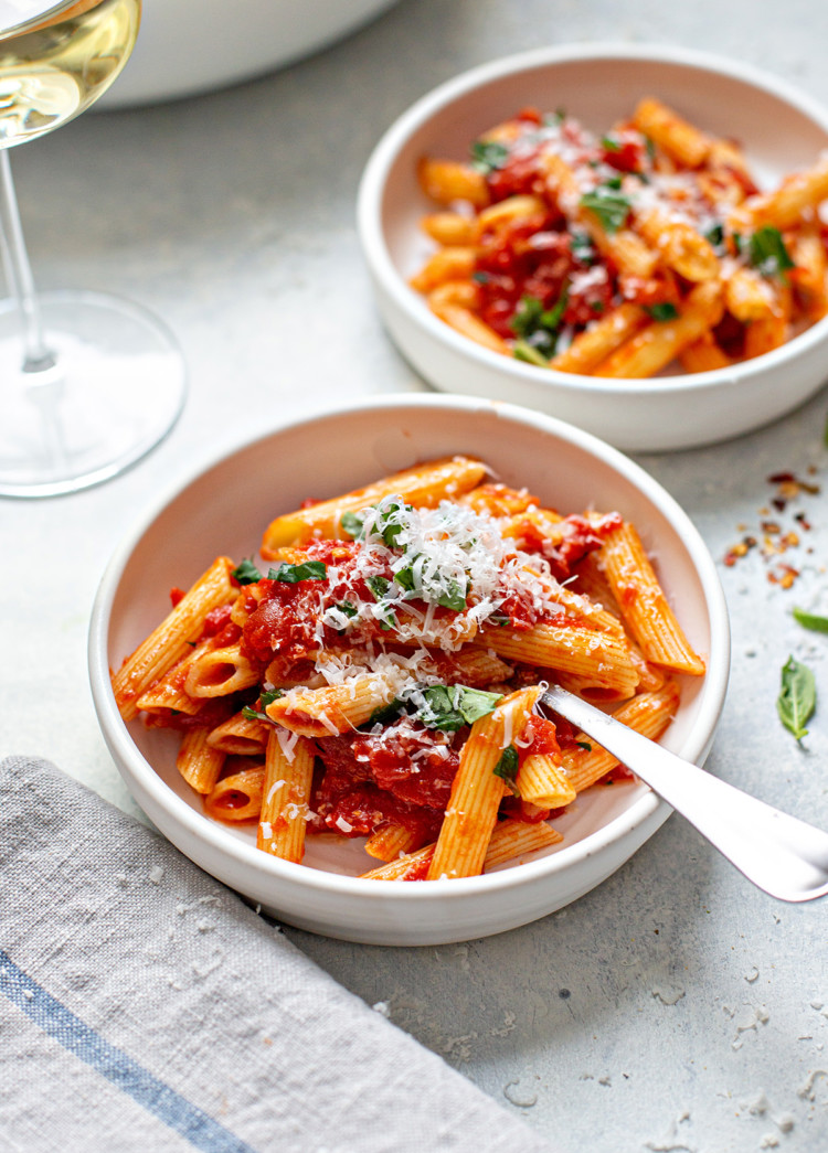 bowls of this pasta arrabiata recipe with parmesan on top