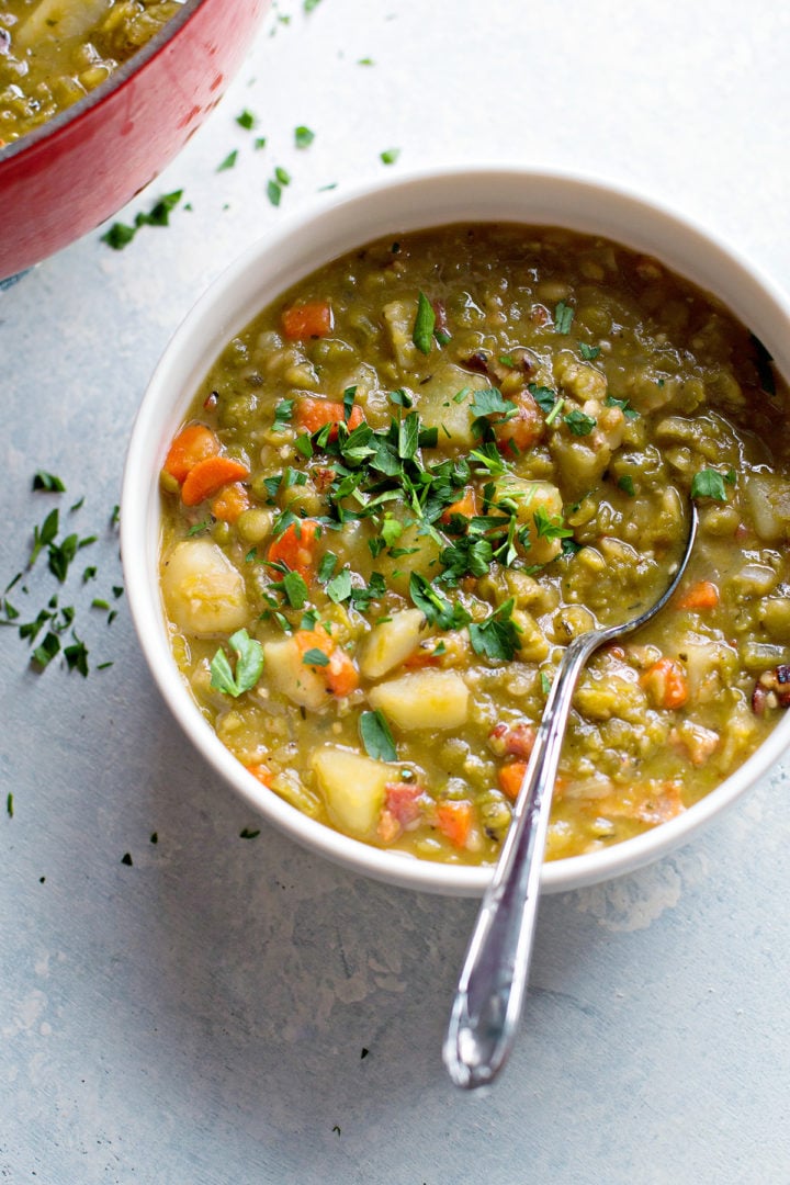 photo of a bowl of split pea soup with bacon on a counter