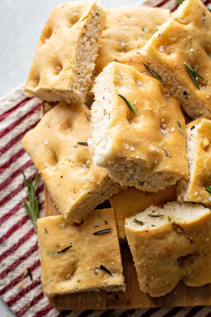 photo of rosemary focaccia cut into squares on a cutting board
