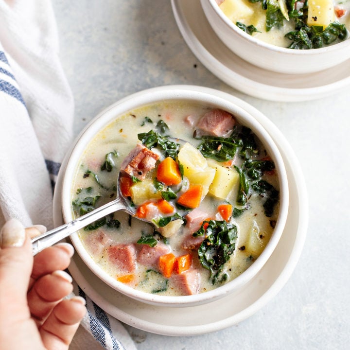 photo of ham soup in a bowl with a spoon