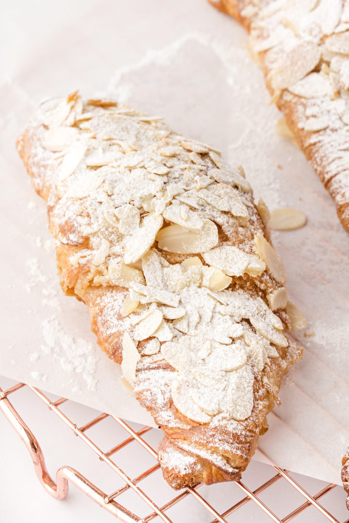 photo of an almond croissant on a wire baking rack