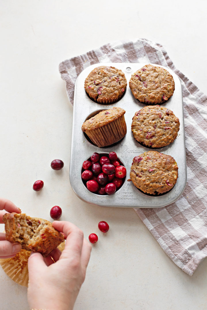 woman eating a cranberry muffin