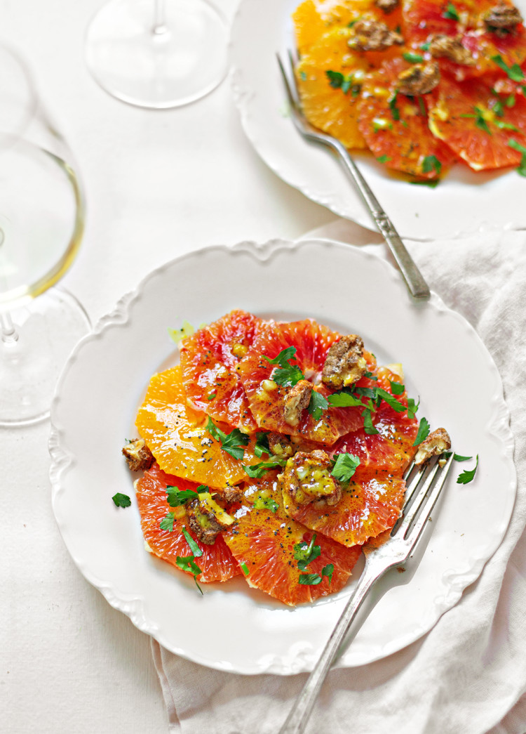 photo of two white dishes plated with a citrus salad