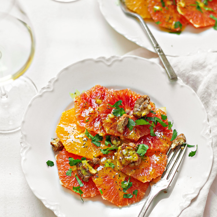 photo of two white dishes plated with a citrus salad