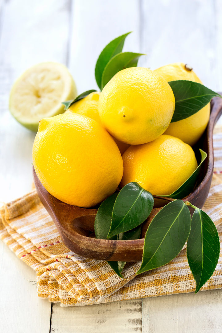 lemons in a wooden bowl for making a lemon twist
