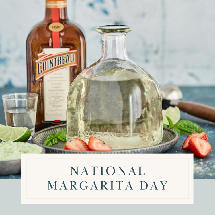 Ingredients for making a margarita recipe, including lime, tequila, and salt, arranged on a table in celebration of National Margarita Day.