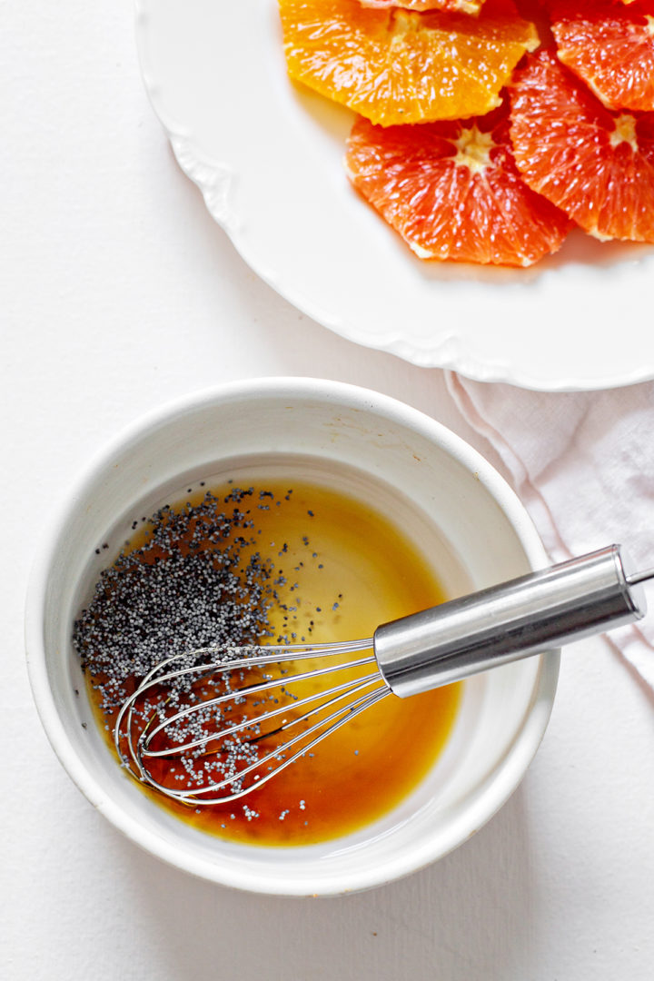 bowl of ingredients in poppy seed salad dressing for a citrus salad recipe