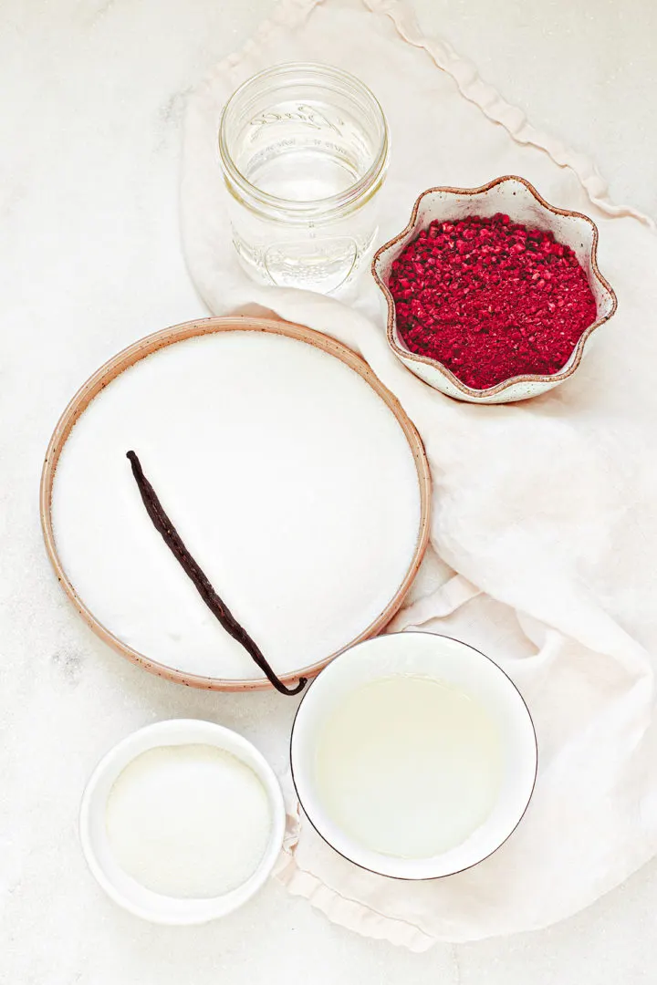 ingredients needed to make this raspberry marshmallow recipe arranged on a white marble background