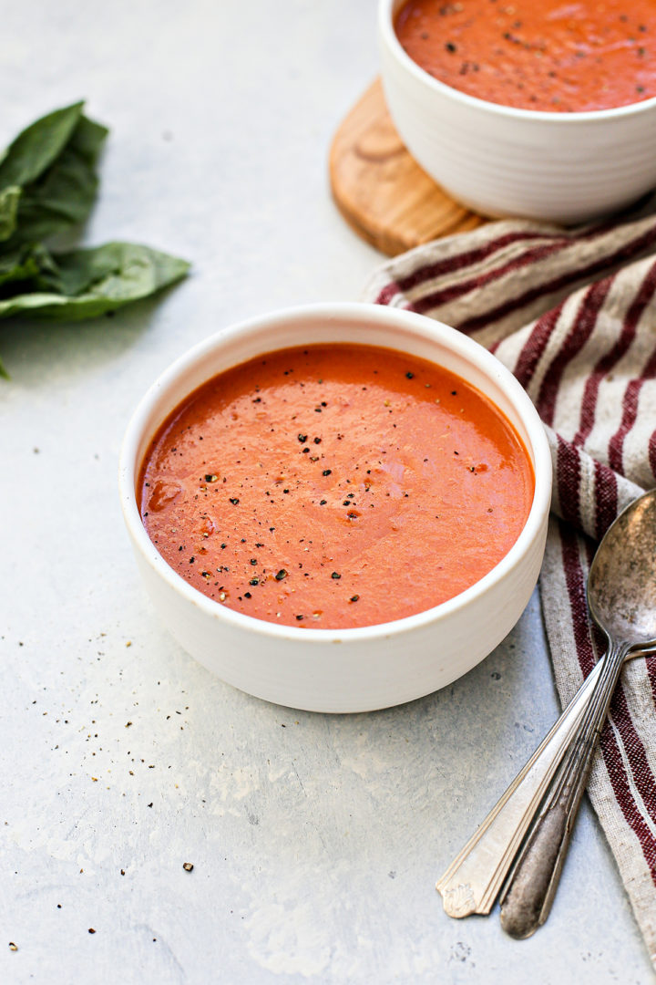 two white bowls full of this homemade tomato soup recipe