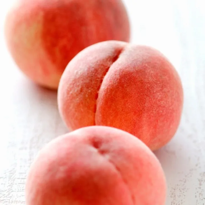 3 fresh peaches ready to be frozen