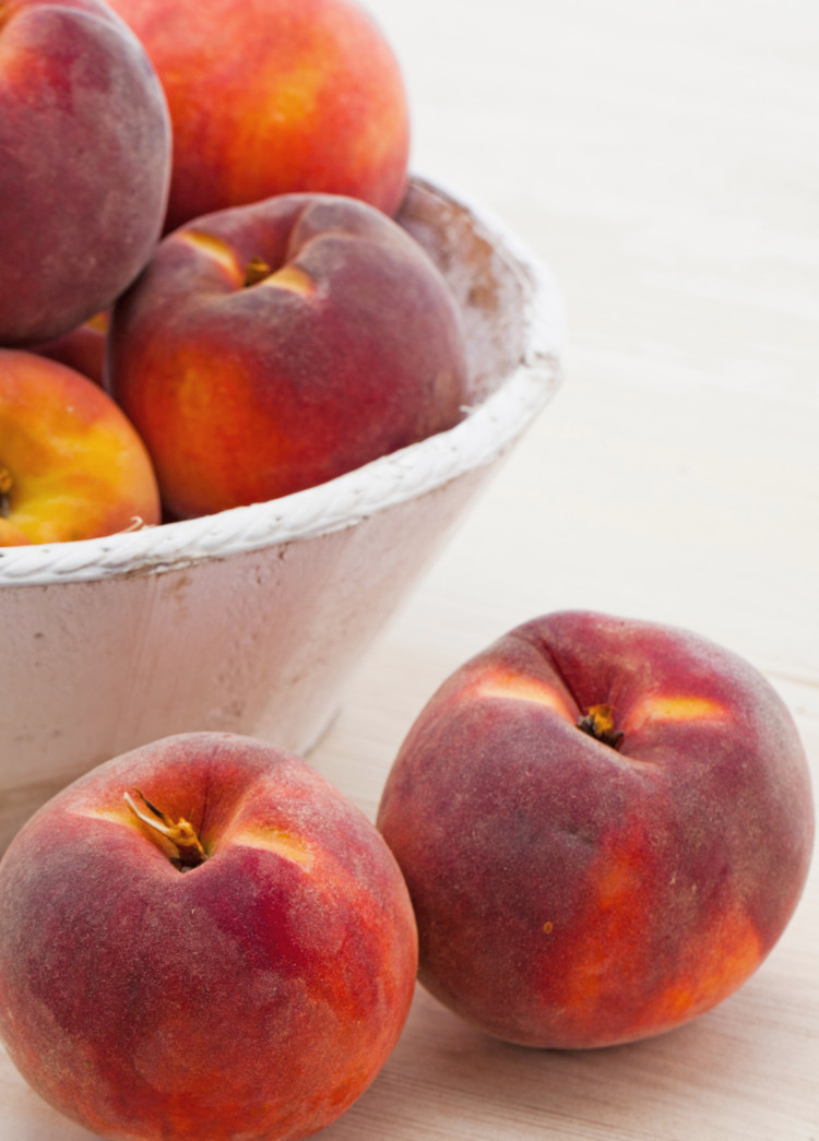 a bowl of fresh peaches for freezing