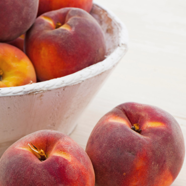 a bowl of fresh peaches for freezing