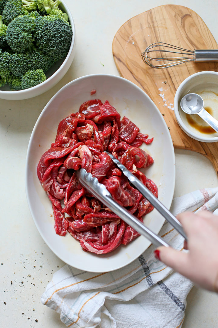 woman preparing the beef for this beef and broccoli chinese stir fry recipe