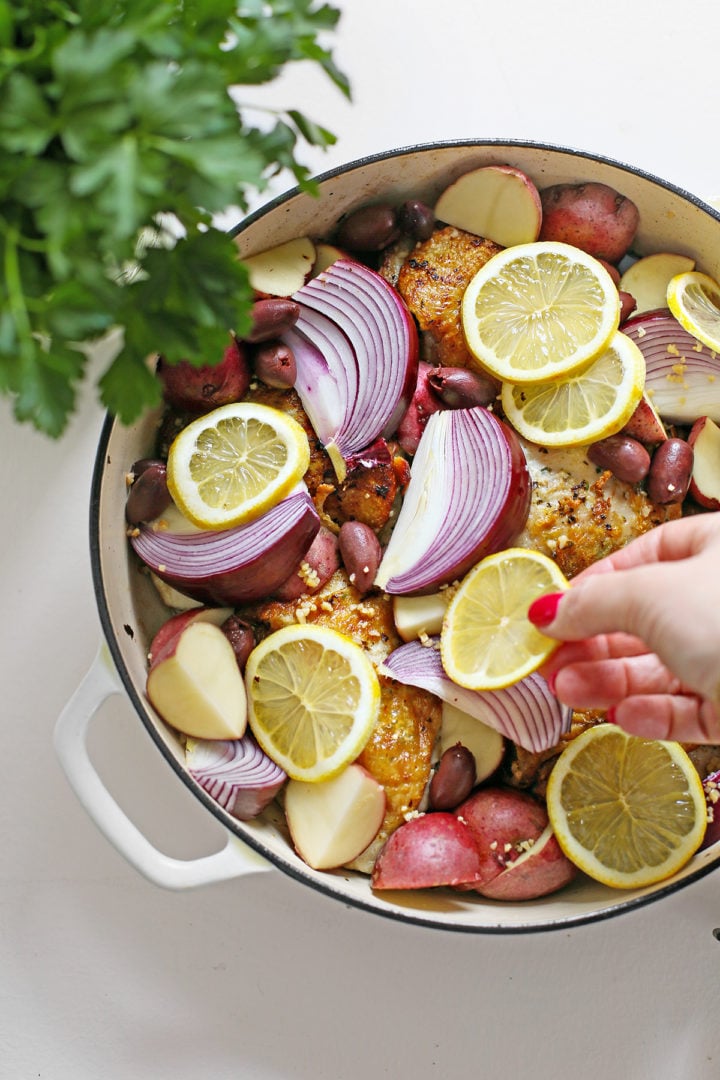 woman preparing this greek chicken thigh oven recipe
