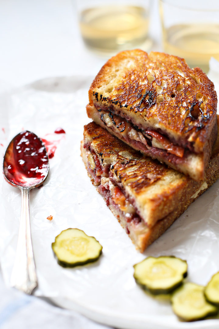 close up photo of a stacked brie grilled cheese sandwich with jam