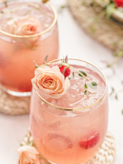 photo of two glasses of a floradora cocktail with fresh raspberries